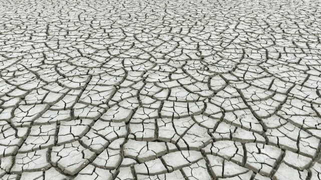 Aerial shot looking down at the cracked surface of a dry lake.