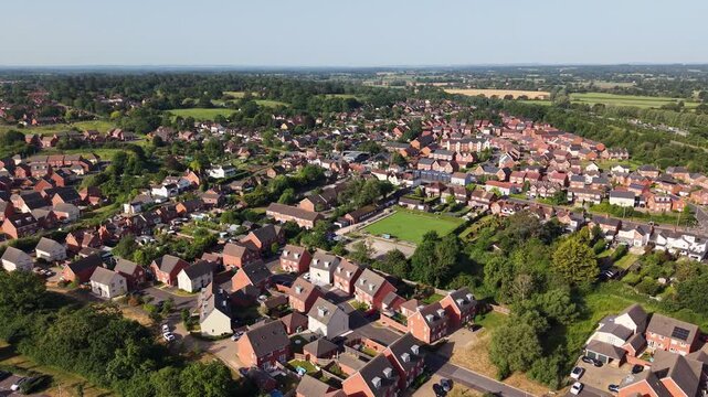 Aerial drone footage of Three Mile Cross in Berkshire, England, showcasing residential neighbourhoods, surrounding countryside, and suburban development