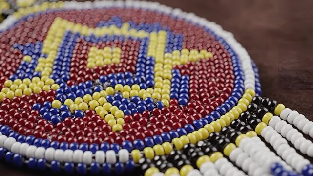 Closeup of Native American beaded medallion with intricate geometric pattern.