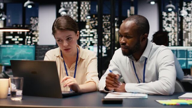 Diverse group of business professionals working together in workspace, collaborating on project assignments. Staff developing strategic agenda to drive company growth and success.