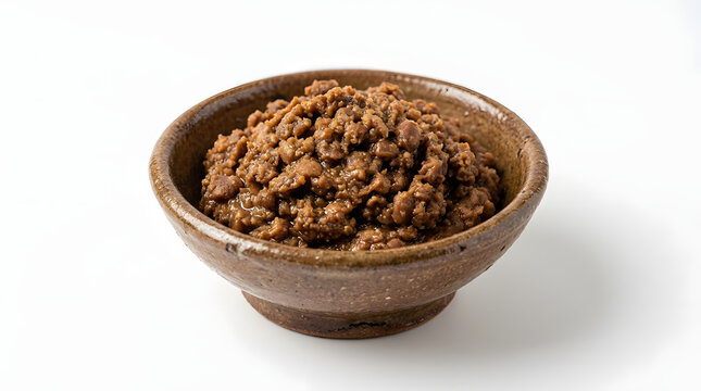 Authentic earthy Korean doenjang fermented soybean paste in a rustic bowl, isolated on a pure white background
