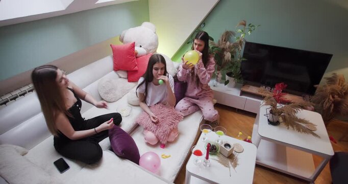 Girls enjoy a fun pijama party at home with friends in the living room creating lasting memories together
