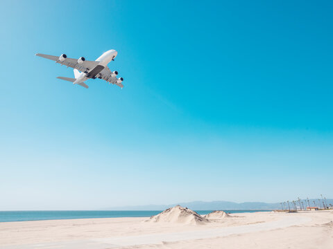 plane landing over the beach at lax in los angeles california