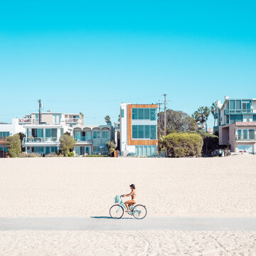 bikini woman bicycle on the beach in los angeles california