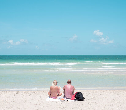 sunburnt couple beach miami florida