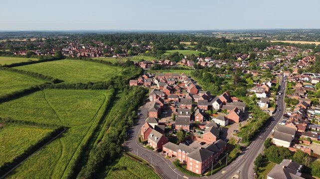 Aerial drone footage of Three Mile Cross in Berkshire, England, showcasing residential neighbourhoods, surrounding countryside, and suburban development