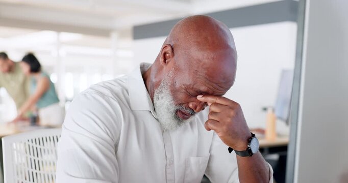 Headache, anxiety and stress of black man at office frustrated with corporate business dilemma. Mature businessman unhappy, sick and tired thinking of career fail, mistake and problem at desk