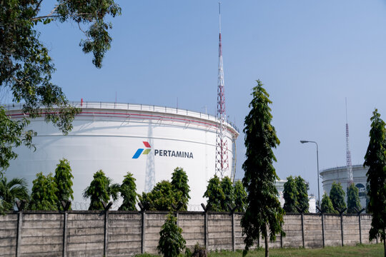 Cilacap, Indonesia - May 13, 2026: Large industrial storage tank with the Pertamina logo under a clear blue sky.