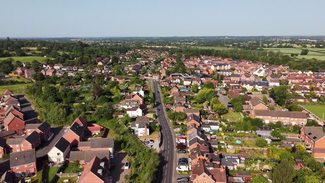 Aerial drone footage of Three Mile Cross in Berkshire, England, showcasing residential neighbourhoods, surrounding countryside, and suburban development
