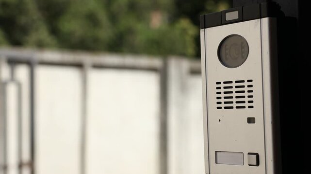 Modern intercom system on gate outdoors, closeup