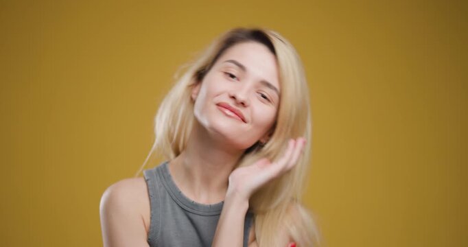 Portrait of a young blond woman with an expressive smile, posing casually