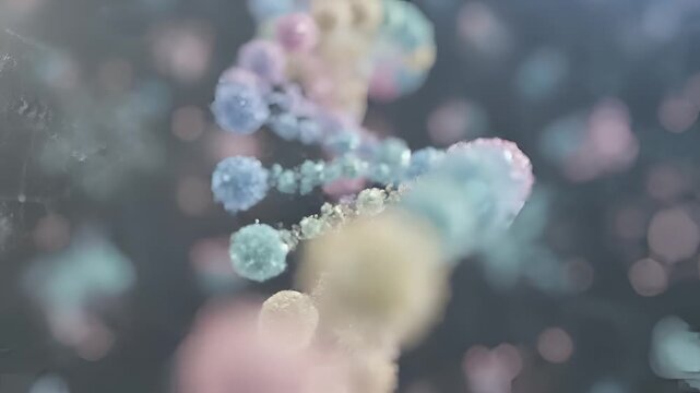 Abstract colorful DNA helix structure rotating slowly in microscopic view.