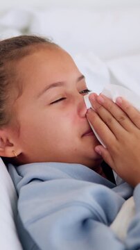 Bed, cough and tissue with sick girl in home for symptoms of disease, illness or infection. Allergies, blowing nose and hayfever with child in apartment bedroom for healthcare, sinusitis or virus