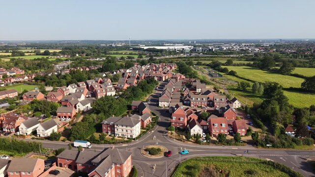Aerial drone footage of Three Mile Cross in Berkshire, England, showcasing residential neighbourhoods, surrounding countryside, and suburban development