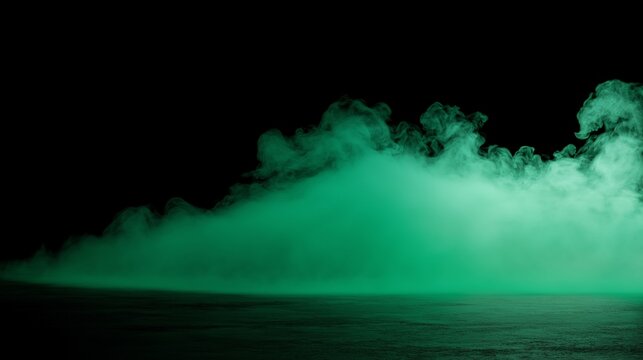 Green dry ice smoke and fog flowing on black background