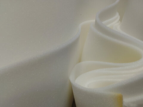 rolls of thin white sponge foam sheets.