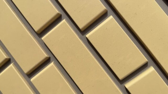 Close-up yellow stone facade panel showing textured brick pattern, warm beige tone and granular surface, recessed mortar joints