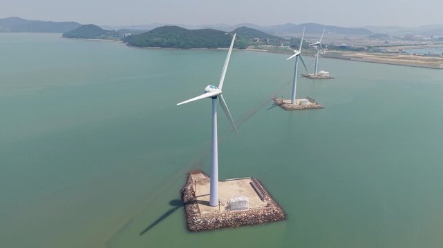 Aerial view of offshore wind turbines standing in green seawater near Tando Sea Road in South Korea