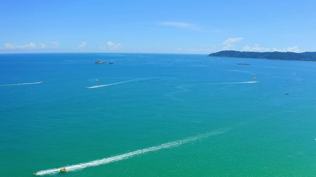 Boats sailing on a turquoise ocean under a clear blue sky
