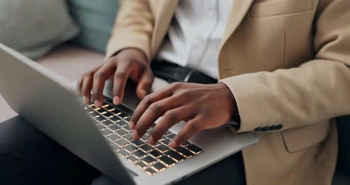 Close up of an businessman typing on laptop computer, working at home.