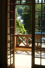 Fototapeta premium Tropical Morning Light Through Open French Doors