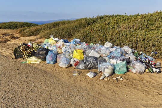 Mountain of rubbish, rubbish bags, plastic waste and old glass in front of a dune landscape by the sea, Costa Verde, western Sardinia, Sardinia, Italy