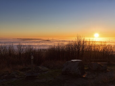 Sunset over cloud cover on mountain top, winter solstice, K&ouml;terberg, L&uuml;gde, Weserbergland, North Rhine-Westphalia, Germany