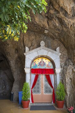 Sanctuary entrance in rock face, red curtains, religious icons, Church of Mary the Fountain of Life, Zoodochos Pigi, rock church, Kefalari, Argolis, Peloponnese, Greece