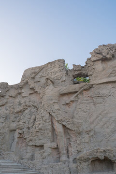 Wall of memory on Mamayev Kurgan. Memorial complex Wall-ruins. Engraved soldiers on a concrete surface.