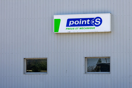 La Tuque, Quebec, 16 May 2026 : Point S sign for tires and mechanics services displayed on a corrugated metal building
