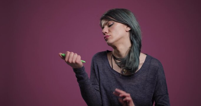 Confident woman holding marker in a creative studio setting, expressive gaze