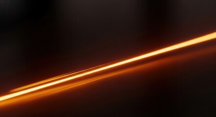 Fototapeta premium Abstract glowing orange light streak on dark background.