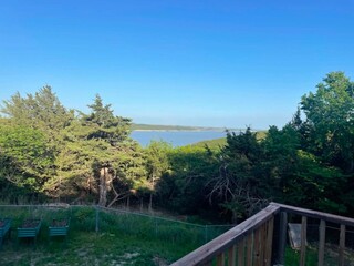 Fototapeta premium Scenic Lake View from a Wooden Deck in Kansas, Green Trees, Blue Sky, Backyard Planter Boxes, Summer Landscape
