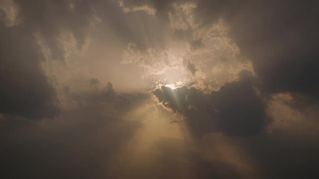 Dramatic timelapse of sunlight piercing through storm clouds with cinematic rays and glowing sky, ideal for weather, spirituality, hope, nature, and atmospheric visual projects.