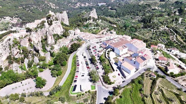 Scenic aerial landscape of historic Guadalest village in Spain surrounded by lush greenery.