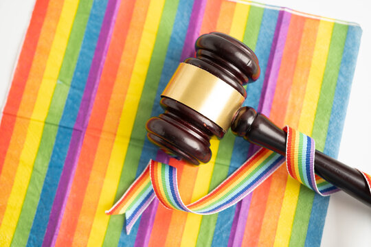 Gavel for judge lawyer on rainbow flag, symbol of LGBT pride month.