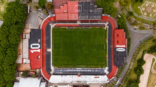 Rosario, Argentina - November 1, 2025: Top-down aerial view of Marcelo Bielsa Stadium, showcasing the geometric arrangement of red and black stands with number 10 tributes, surrounded by parkland