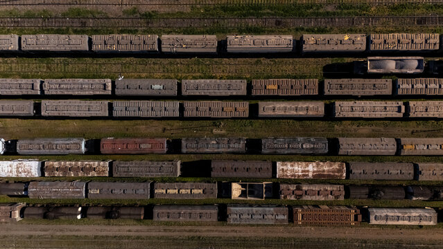 Aerial top view of long freight trains lined up on railway tracks in Rosario, Argentina, representing logistics and transport infrastructure