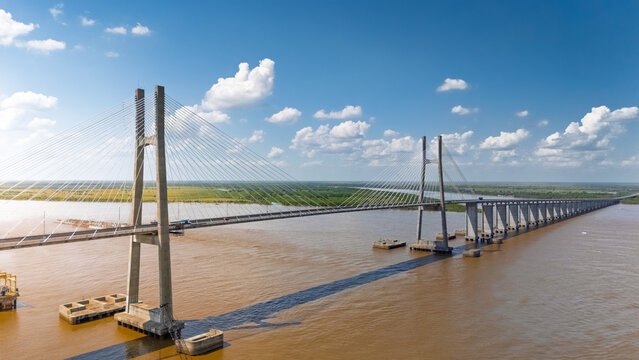 Aerial view of the cable-stayed Rosario-Victoria Bridge spanning the wide Parana River, showcasing concrete towers and modern infrastructure in Rosario, Argentina