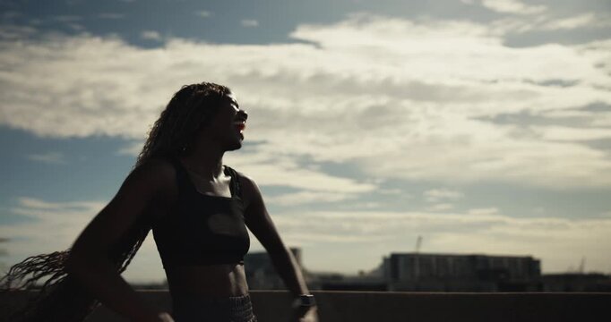 Fist pump, time and wind with woman runner outdoor on bridge for achievement or milestone. Celebration, exercise and watch with happy athlete cheering for fitness, running success or training