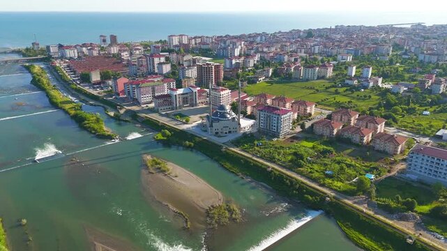 Ardeshen, Turkey. Ensar Mosque with twin minarets and large central dome, aerial view over the Firtina River estuary on a bright sunny morning with the Black Sea beyond. Aerial View, MasterShots, Cir