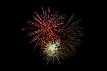 Obraz premium Fireworks with dark sky background. Green, red, and white and gold. Independence Day celebration, Santa Clarita, California. 