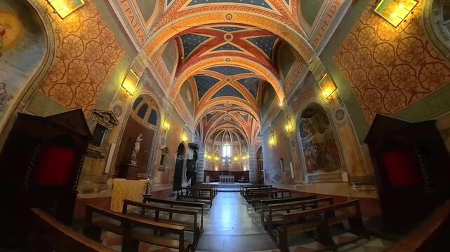 Interior of Sant Andrea church with vaulted ceiling frescoes and altar in Spello Umbria Italy