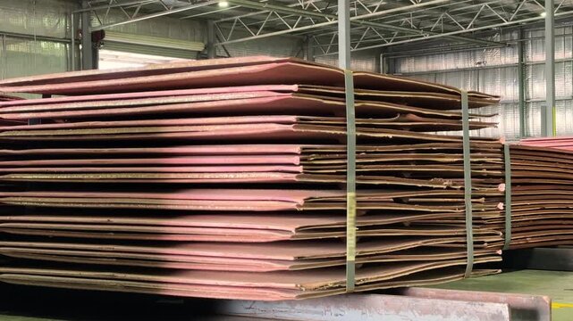 Refined copper cathodes are meticulously stacked in large quantities at the BHP Olympic Dam copper mine. These stacks of shiny copper are worth thousands of tens of thousands of dollars.