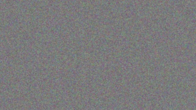 Cinematic film grain texture overlay with subtle noise on gray background, seamless loop