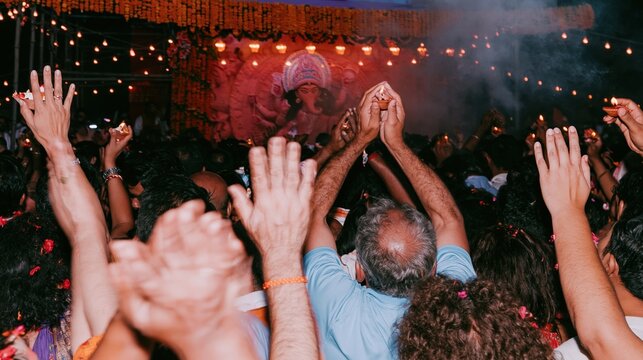 Crowd of devotees raising hands in prayer during a traditional festival for cultural documentation, religious news coverage and South Asian travel