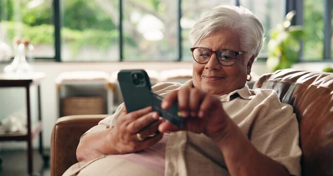 Old woman, smartphone and credit card for online shopping in home, purchase or checkout with account info. Senior female person, ecommerce or internet banking with transaction for payment at house