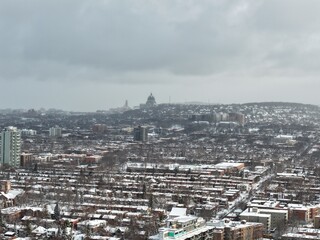 Naklejka premium Saint Josephs Oratory dome above snowy Westmount and Montreal neighborhood on Mount Royal hill in winter, Quebec, Canada. g.