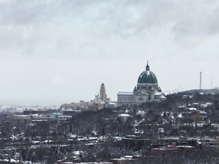 Saint Josephs Oratory dome above snowy Westmount and Montreal neighborhood on Mount Royal hill in winter, Quebec, Canada. g. © Artem Onoprienko