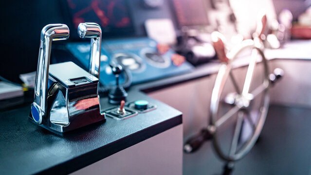 Throttle control on modern boat dashboard with navigation system and radar monitor screen in ship captain bridge or motorboat control room. Wheelhouse steering console. Nautical vessel technology
